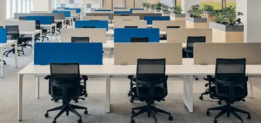 Modern open-plan office space featuring clean workstations, ergonomic chairs, and sanitized carpets provided by professional office cleaning services in Toledo, OH.