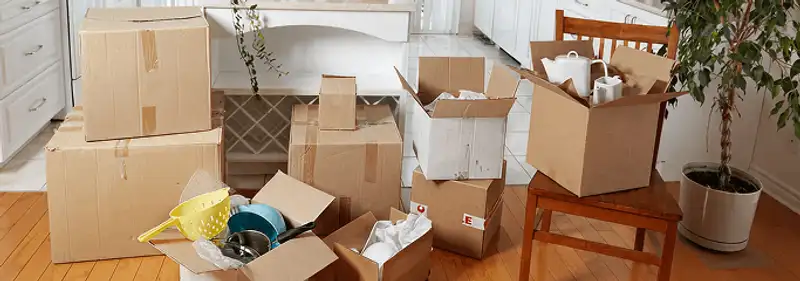 Packed moving boxes and household items in a kitchen before move-out or move-in cleaning, Toledo, OH.
